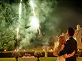 bridegrooms in their wedding car look fireworks