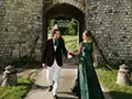 the bride and groom in front of the medieval postern