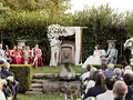 the bride and groom and their guests in the park