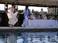 bride and groom around the chateau's pool