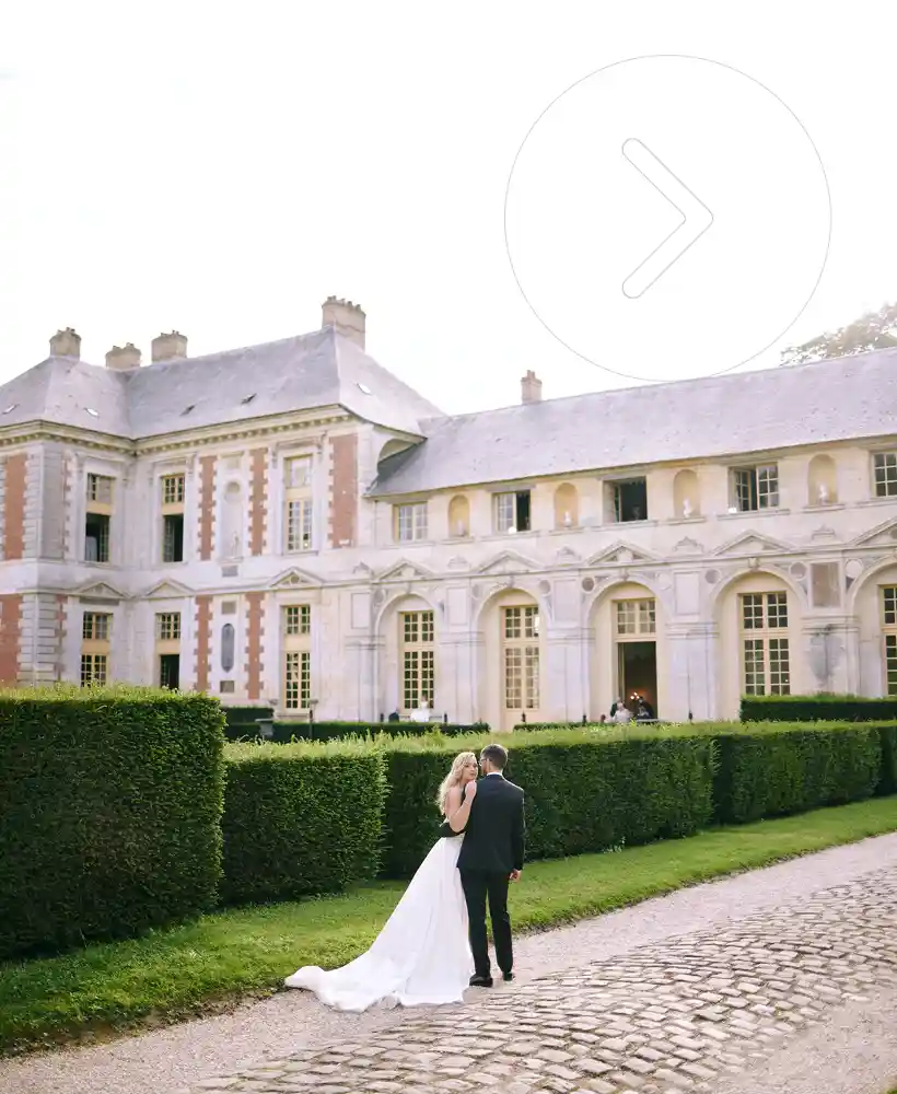 the bride and groom in the grounds of the chateau