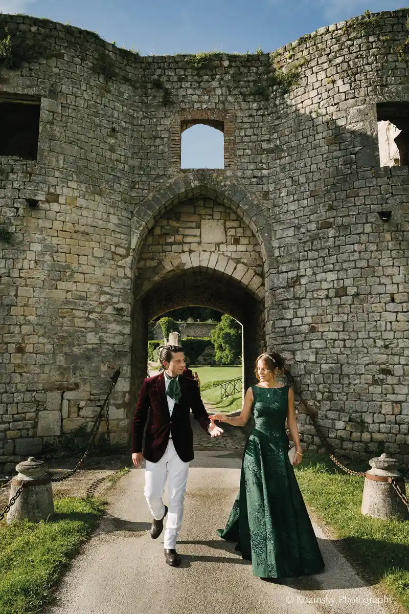 the bride and groom in front of the medieval postern