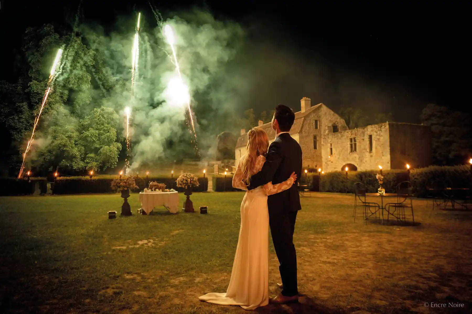 bridegroom and fireworks in the chateau grounds