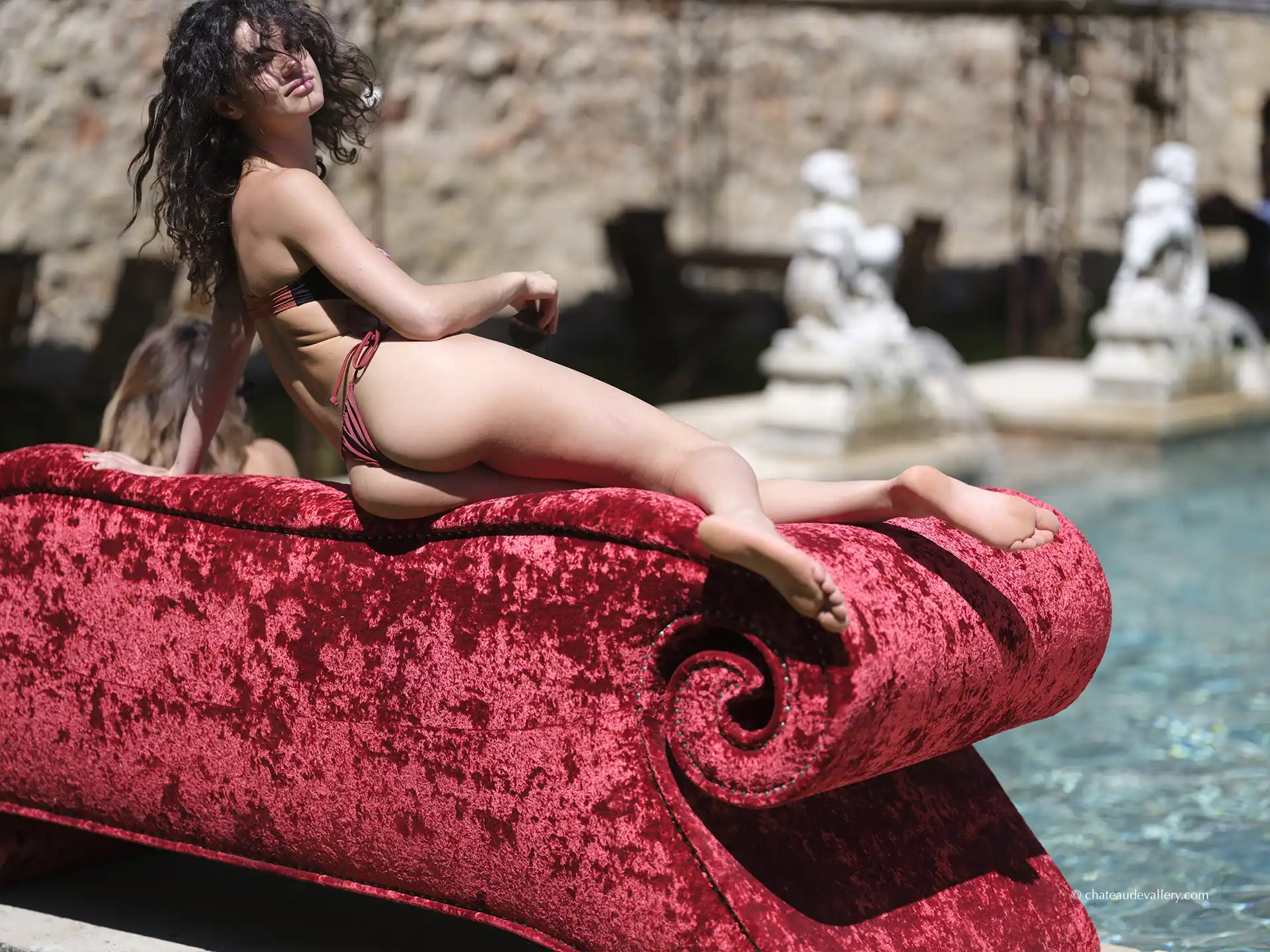 red sofa around the pool