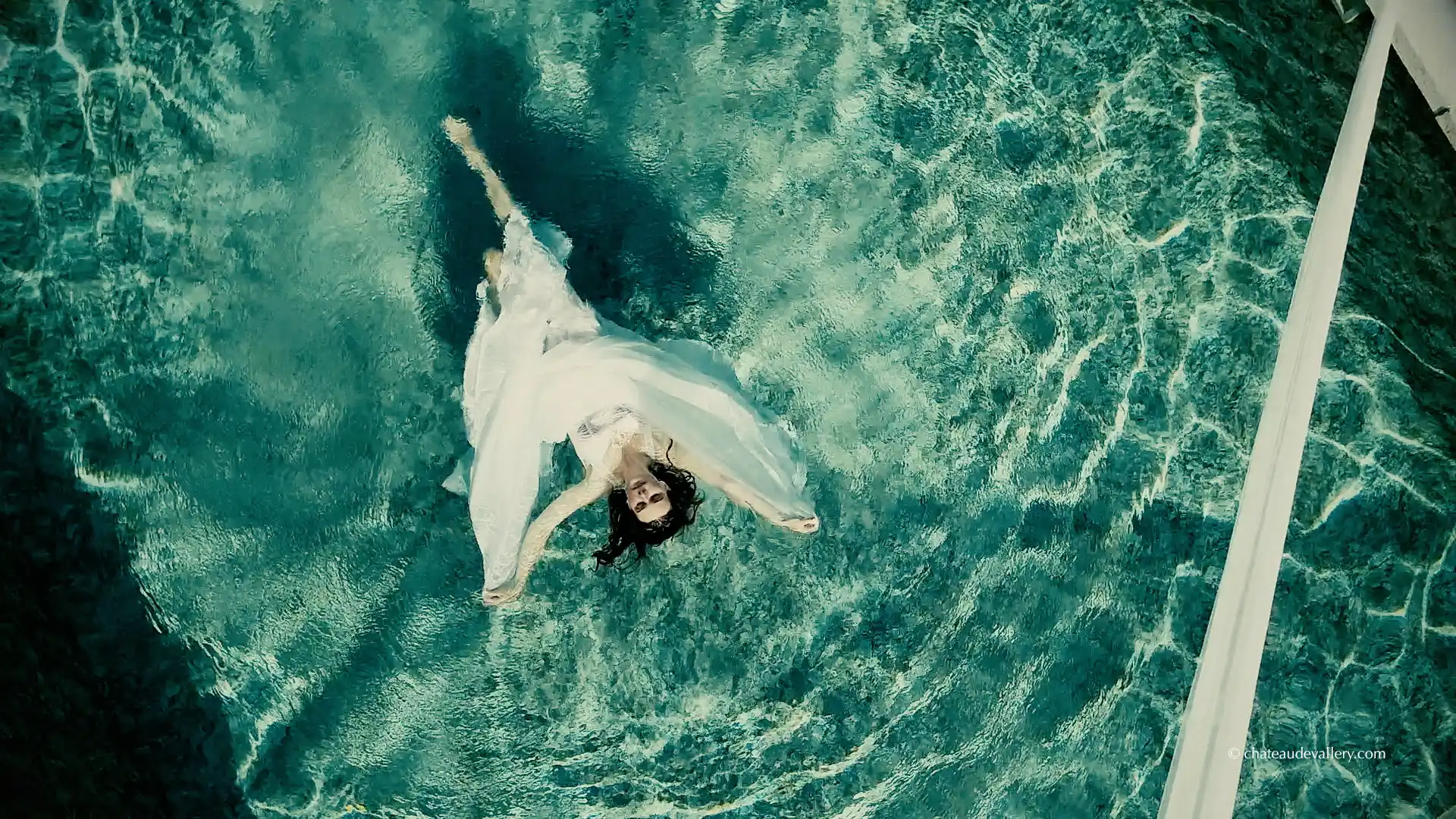 model in pool aerial view