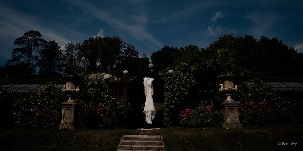 wedding dress hanging in the arbour of the chateau